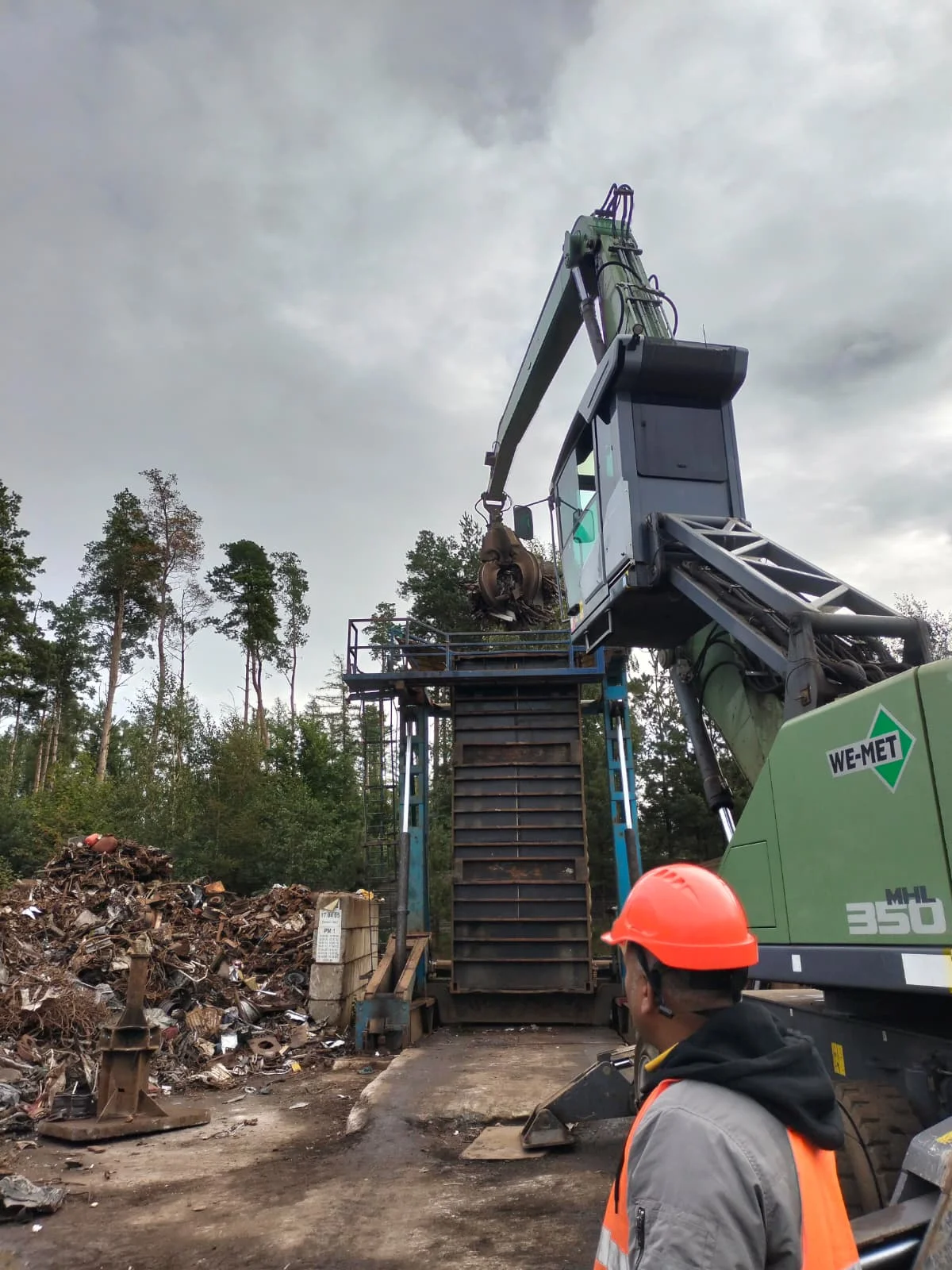 Inspector examining metal scrap at an industrial yard